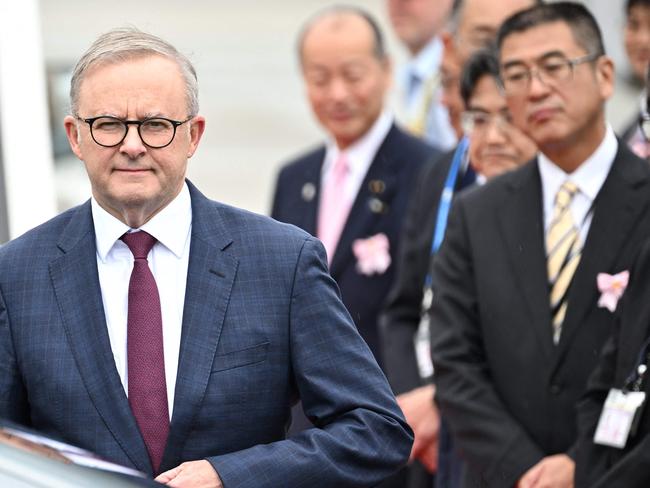 Australia's Prime Minister Anthony Albanese (L) arrives at Hiroshima airport in Mihara, Hiroshima prefecture on May 19, 2023, to attend the first day of the G7 Leaders' Summit. (Photo by Philip FONG / AFP)