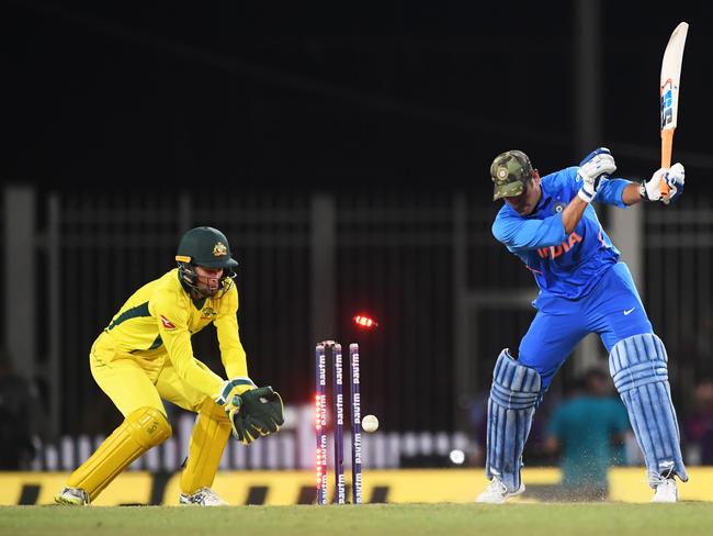 Indian cricketer Mahendra Singh Dhoni is clean bowled by Adam Zampa. Picture: Dibyangshu Sarkar/AFP