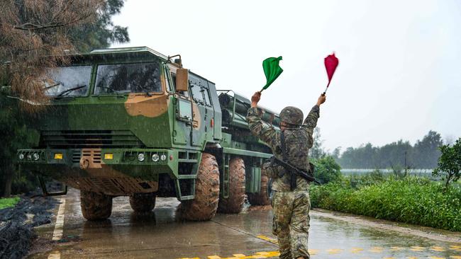 A Chinese soldier directs a rocket launcher into position in eastern China. Picture: AFP