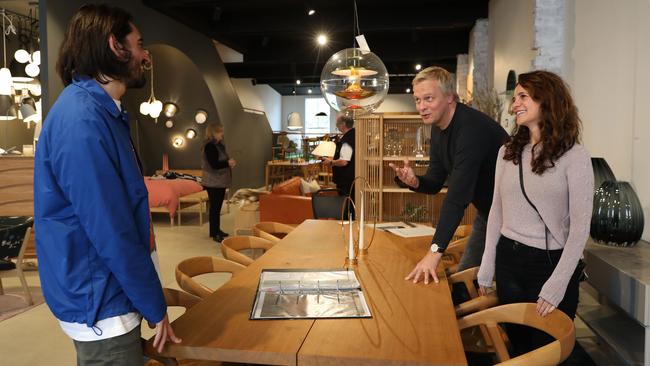 Catherine Cassimatis and John Wisselink talking to retail assistant Marco Vella while maintaining social distancing at Great Dane Picture: Jane Dempster