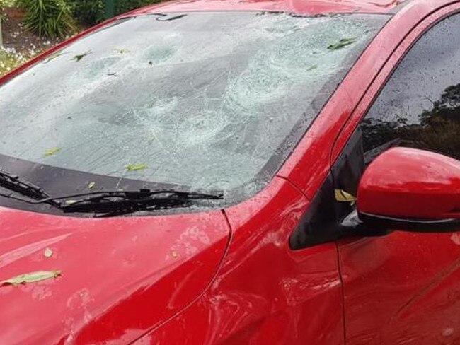 A car is heavily damaged after being battered by hail during a storm on Saturday, October 31. Picture: Supplied/.Twitter