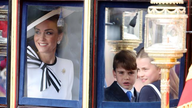 Catherine, Princess of Wales, Prince Louis and Princess Charlotte ride in the glass State Coach during the King’s Birthday Parade. Picture: Getty Images.