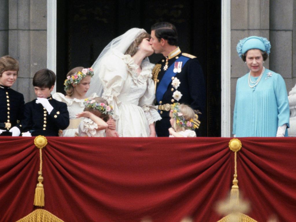 1981: The Queen is seen on the famous Buckingham Palace balcony while Prince Charles and Diana kiss after their wedding. Picture: Paul Gilham/Getty Images