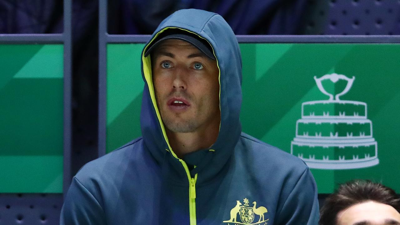 John Millman watches the Australian team after his loss in Davis Cup singles.