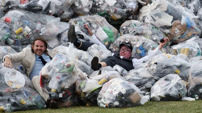 Racegoers jump into a pile of garbage at the end of the day. Picture: Tracey Nearmy/AAP