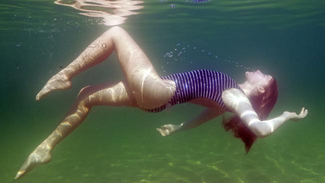 Circus performer Jessica Mews underwater at Shelly Beach in Manly. Picture: Tim Hunter