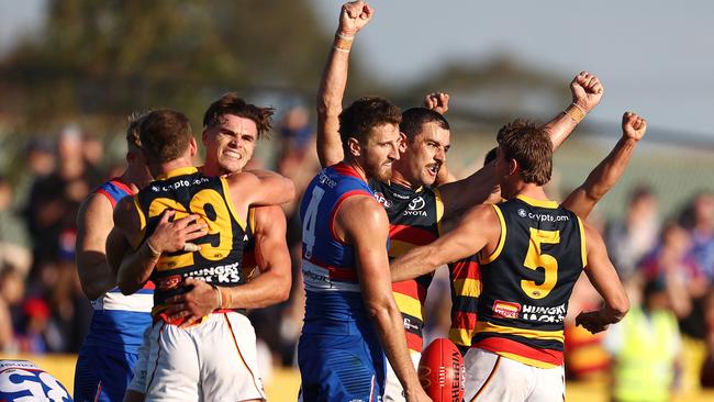 Taylor Walker and his Adelaide teammates celebrate as the final siren sounds. Picture: Michael Klein