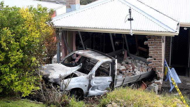 The stolen ute was dumped and then torched. It rolled down the hill and crashed into the front of a house. Picture: NIKKI DAVIS-JONES