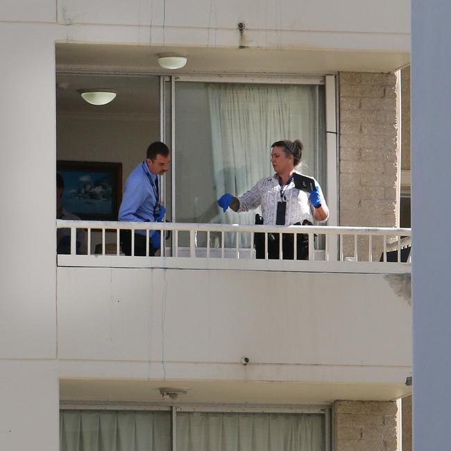 Police on a balcony of the View Pacific Resort as they investigate the alleged murder. Picture: Glenn Hampson