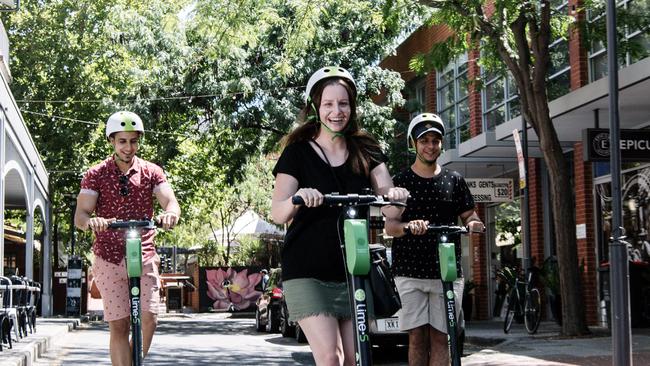 Ayman Kasim of Woodville, Natasha Taylor of Hallett Cove and Akram Kasim of Woodville riding the Lime Scooters for the first time in Adelaide. Picture: AAP Image/ Morgan Sette