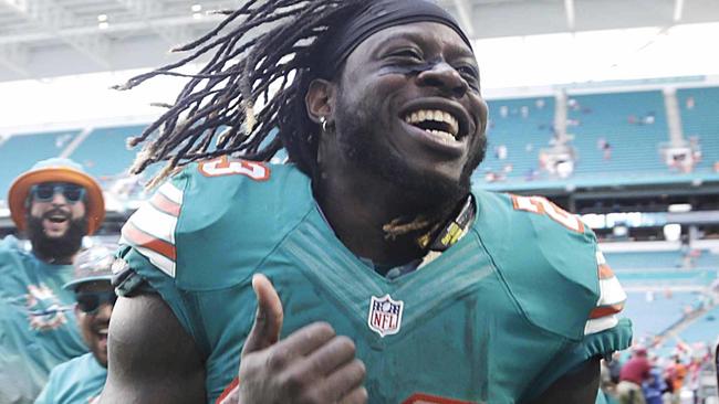 Miami Dolphins running back Jay Ajayi is congratulated as he leaves the field at the end of an NFL football game against the Buffalo Bills.
