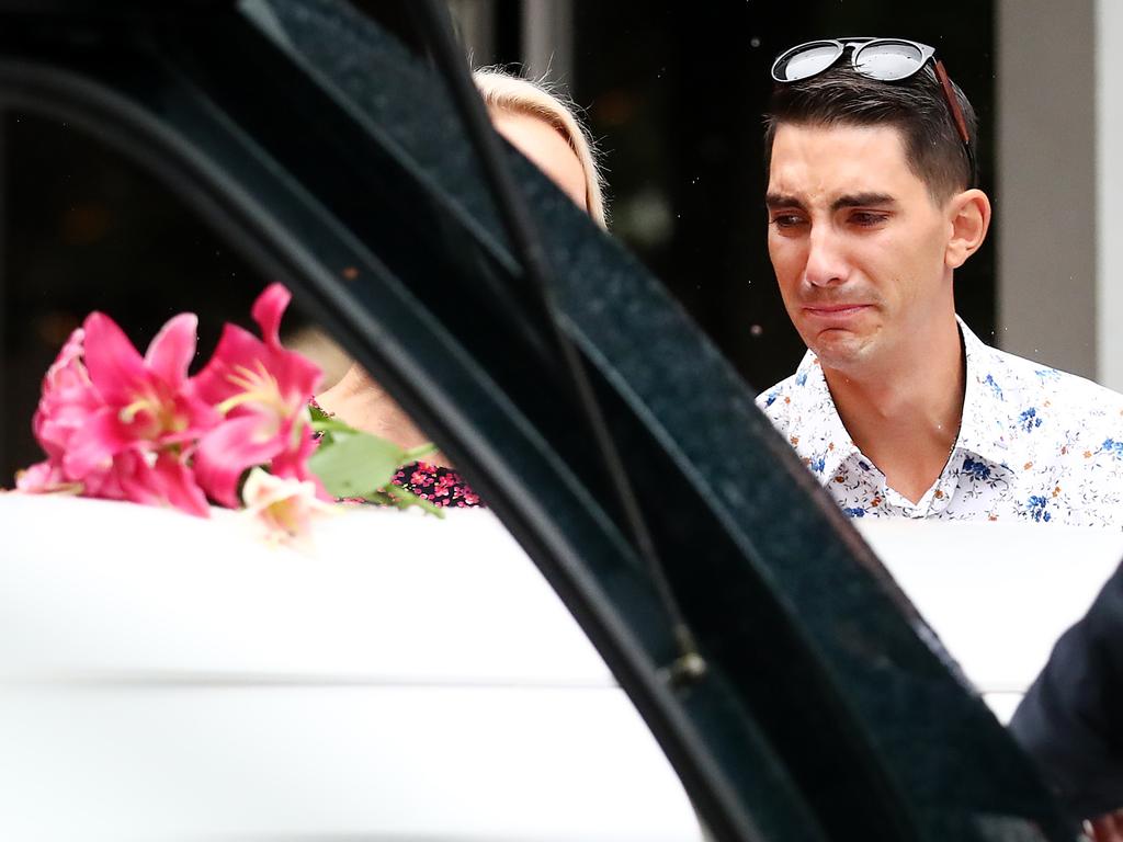 Nathaniel Clarke, brother of Hannah Clarke, looks on as the coffin is placed in the hearse. Picture: Jono Searle/AAP