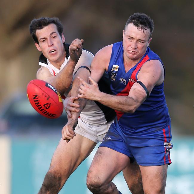 Terang-Mortlake’s Lewis Taylor fights for possession of the ball with Koroit’s Taylor McKenry on Saturday.