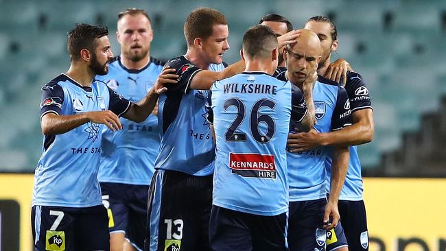 Sydney FC players celebrate with Adrian Mierzejewski after he scored a free-kick against Melbourne City.