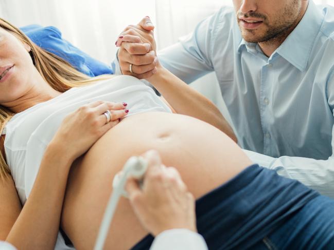 Ultrasound Examination In Doctors Office. Woman and her man in doctors office doing ultrasound examination  Picture: Istock