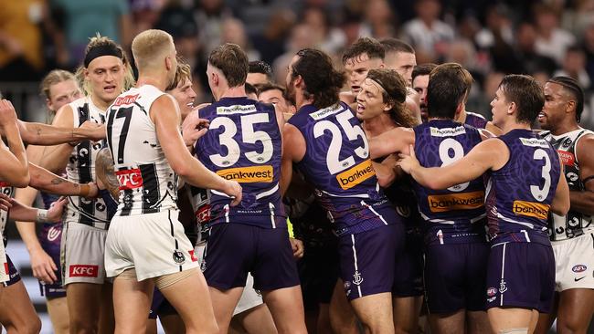 PERTH, AUSTRALIA - MAY 24: Team mates get involved as Brayden Maynard of the Magpies and Nat Fyfe of the Dockers wrestle during the round 11 AFL match between Walyalup (the Fremantle Dockers) and Collingwood Magpies at Optus Stadium, on May 24, 2024, in Perth, Australia. (Photo by Paul Kane/Getty Images)