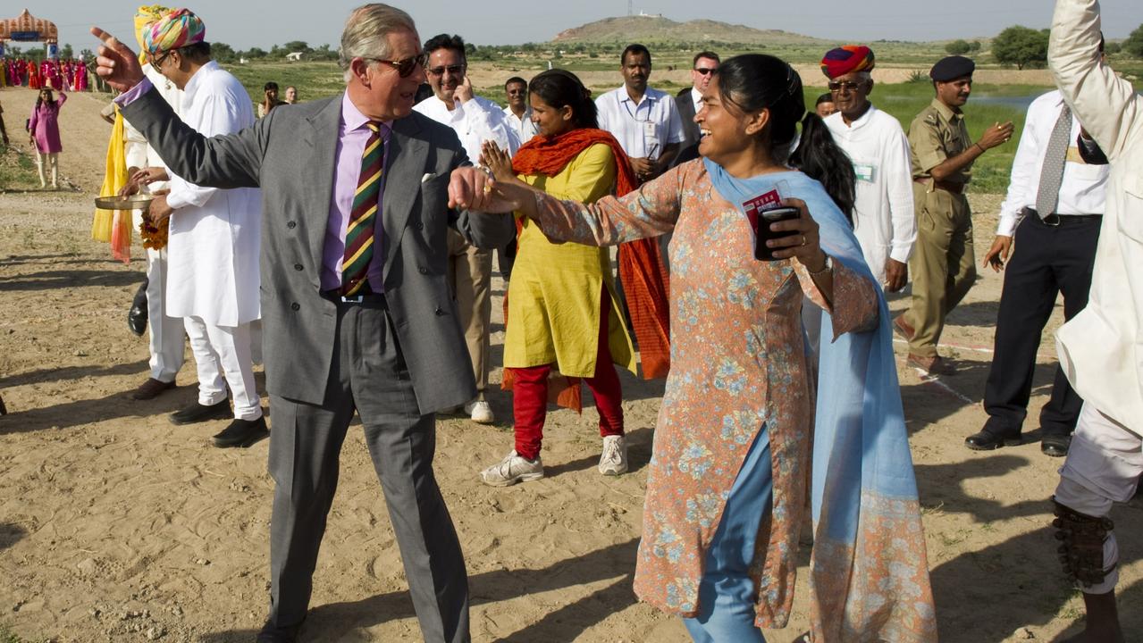 The Prince of Wales dances in the Rajasthan in India, to celebrate garnering enough water for two years for desert crops, thanks to a dam built with funds from his water aid charity. Picture Arthur Edwards