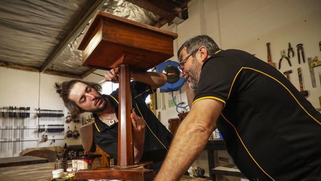 Gough and McLaughlin restore a drawer. Picture: Sean Davey