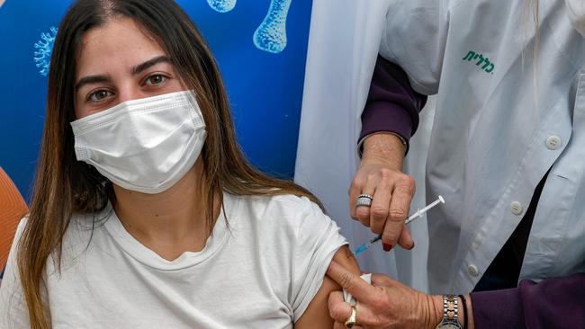 An 18-year-old girl receives a dose of the Pfizer-BioNtech COVID-19 coronavirus vaccine at Clalit Health Services, in Israel's Mediterranean coastal city of Tel Aviv. Picture: AFP