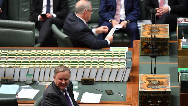 Prime Minister Scott Morrison (top) and Leader of the Opposition Anthony Albanese (bottom) look to support from their benches during Question Time. Picture: AAP