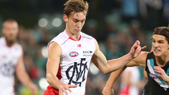 Oscar McDonald gets a clearing kick for Melbourne against Port Adelaide. Picture: Getty Images.