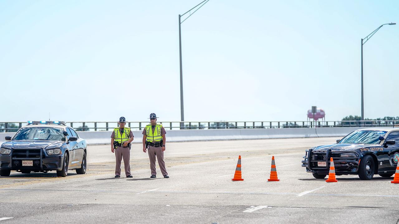 Florida State Troopers block traffic over the Bayou Grande Bridge leading to the Pensacola Naval Air Station. Picture: AFP