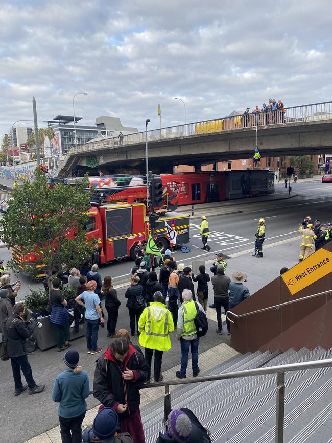 Extinction Rebellion protester's near morphett Street Bridge this morning, with one hanging from the bridge on a rope. Picture: Agnes Gichuhi