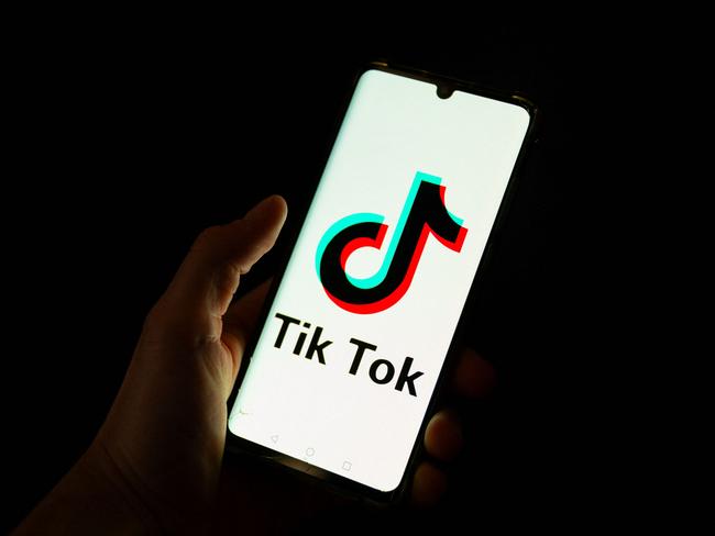 (FILES) This photograph taken on April 19, 2024 shows a man holding a smartphone displaying the logo of Chinese social media platform Tiktok in an office in Paris. Albanian Prime Minister Edi Rama announced on December 21, 2024, that the government will shut down social network TikTok for at a least a year starting at the beginning of 2025. (Photo by Antonin UTZ / AFP)