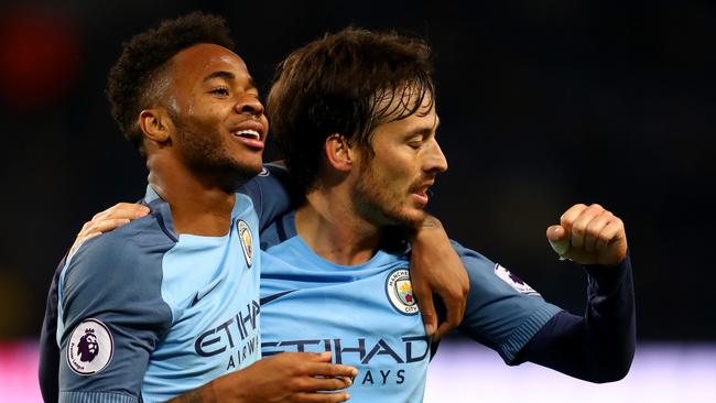 David Silva (R) of Manchester City celebrates scoring his team's second goal.