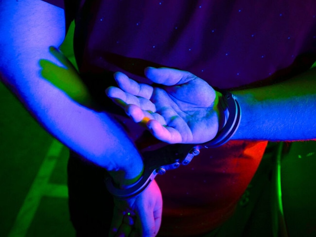 Cairns police generic handcuffs night