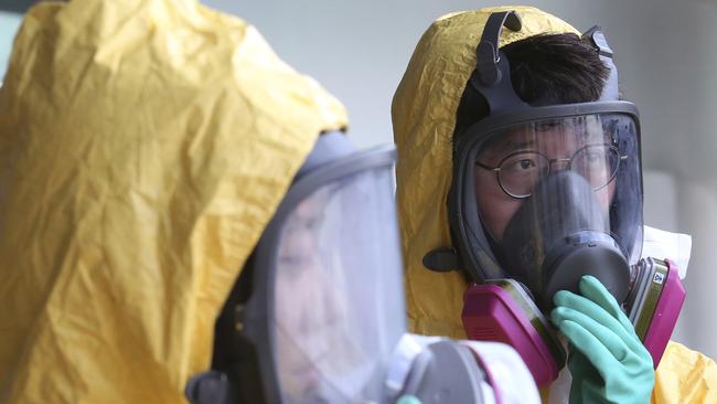 South Korean government officials wearing gas masks attend an anti-terror drill as part of Ulchi Freedom Guardian exercise, in Goyang, South Korea. Picture: AP Photo/Ahn Young-joon.