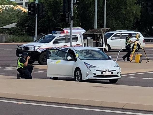 Police investigators at the scene of the crash between a car and a cyclist near the intersection of Tiger Brennan Dr and Stoddart Dr this morning