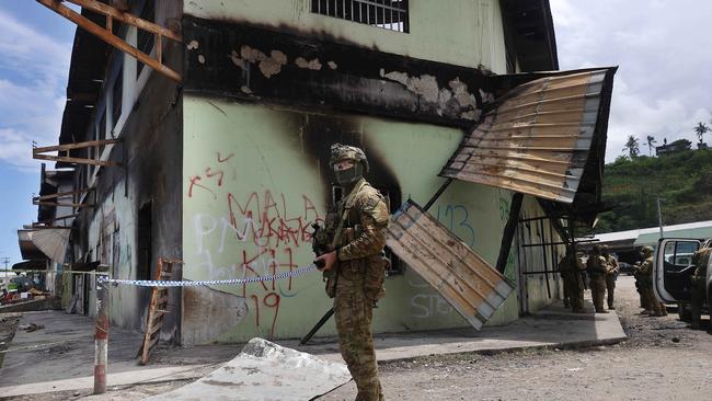 Australian soldiers conducted a brief patrol of a burnt out area in China Town, Honiara, Solomon Islands.