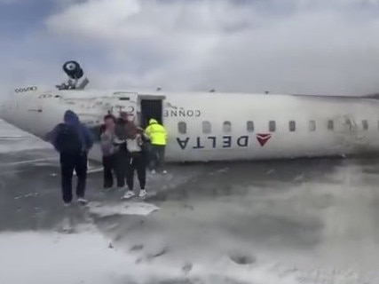 Survivors walk from the wreckage of the Delta Airlines plane. Picture: Supplied