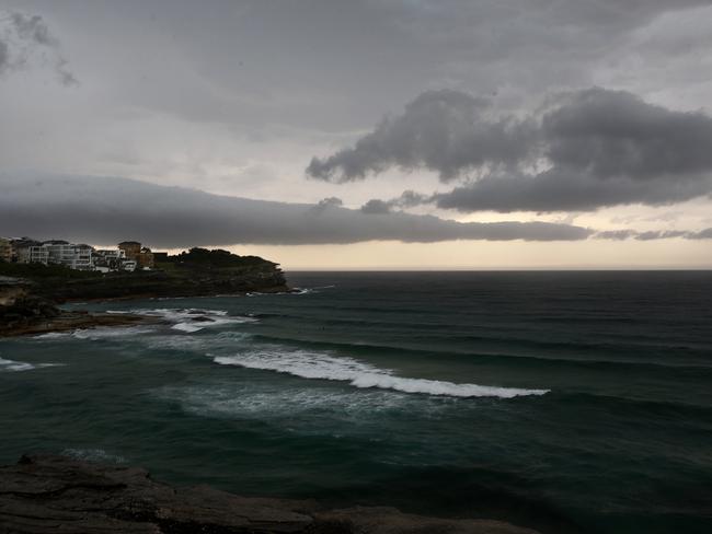 Dark clouds over Tamarama as thunderstorm casts a broody gloom over Sydney. Picture: John Appleyard