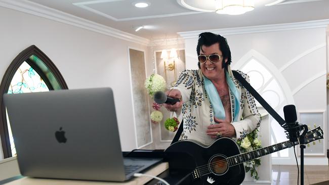 Elvis Presley impersonator and chapel co-owner Brendan Paul performs a live wedding vow renewal ceremony using the Zoom videoconferencing. Couples can invite up to 100 guests to watch their ceremony live via Zoom. Picture: Ethan Miller/Getty Images