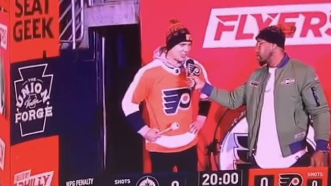 Manly Sea Eagles fullback Tom Trbojevic beats the drum during the pregame show at the Philadelphia Flyers' NHL game.