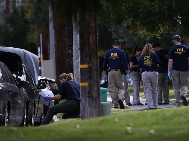 Ongoing search for clues ... FBI investigators examine a car that allegedly belonged to Syed Farook in Redlands, California. Picture: Justin Sullivan