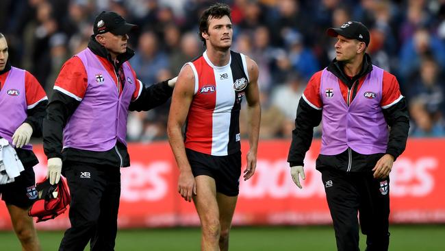 Dylan Roberton is helped by St Kilda medical staff after collapsing against Geelong last year.