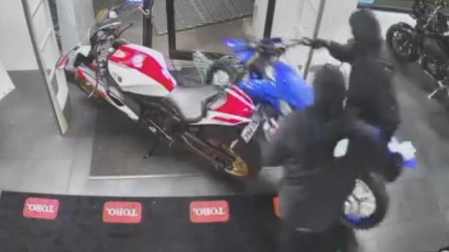 Watch: Masked bandits smash through showroom, steal motorbikes