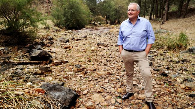 Prime Minister Scott Morrison stands in a dry riverbed while visiting the Dungowan Dam near Tamworth to announce $1 billion dollars in new funding for dams in NSW. Picture: Adam Taylor/PMO