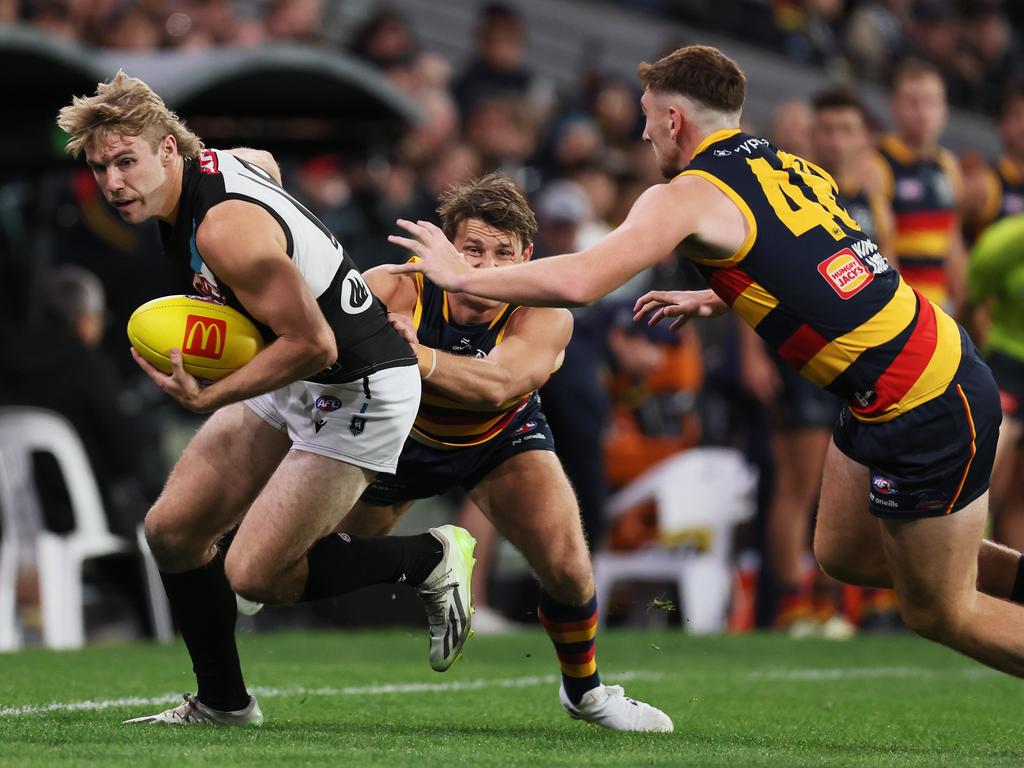 Jason Horne-Francis breaks away from Crows Matt Crouch and Mark Keane the first Showdown of 2024. Picture: James Elsby/AFL Photos