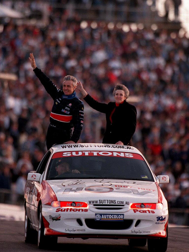 Retiring touring car driver Peter Brock and his wife Beverley wave to spectactors from back of Holden Racing Team Commodore during farewell lap at Sydney’s Oran Park. Picture: Supplied