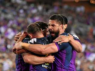 Storm players celebrate after scoring a try during the NRL grand final 2017. Police are bracing themselves for a spike in family violence this grand final weekend. Picture: MICK TSIKAS