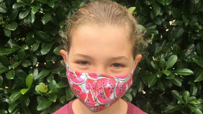 Katerina McGilchrist wears a mask as she encourages people to donate them to the needy. Picture: supplied