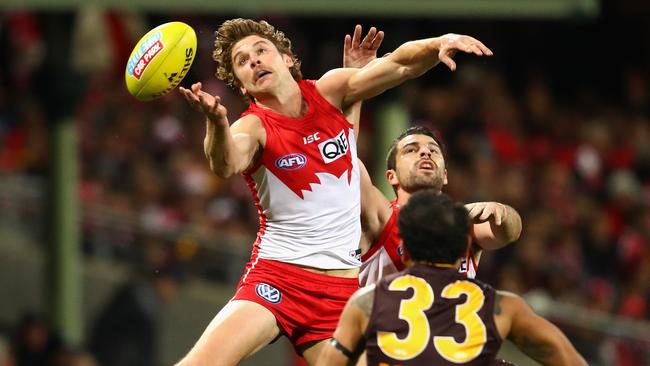 Dane Rampe takes a flying leap over Hawthorn’s Cyril Rioli.