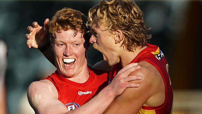 Hugh Greenwood reacts with Matthew Rowell during their win over the Crows. Picture: AAP