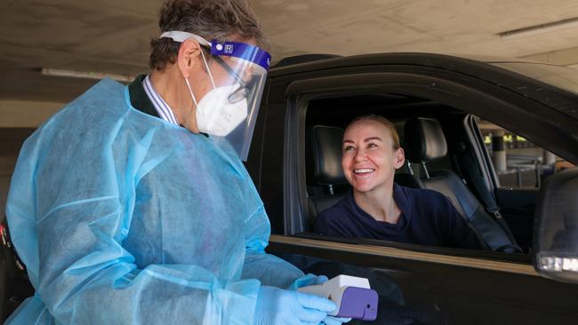 Dr John Saxon testing jockey Kathy O'Hara with a rapid testing Covid-19 machine at Randwick Racecourse on Wednesday. Picture: Justin Lloyd.