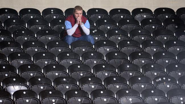 An Aston Villa supporter tries to digest the loss.