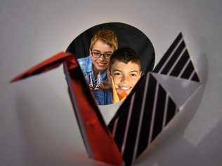 THROUGH THE LENS: 12-year-old Michael Timmers has turned his battle with brain cancer and loss of vision into a positive by making origami with his brother Pieter. Picture: John McCutcheon